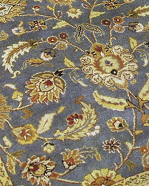 Blue Persian-style rug with gold floral pattern after cleaning