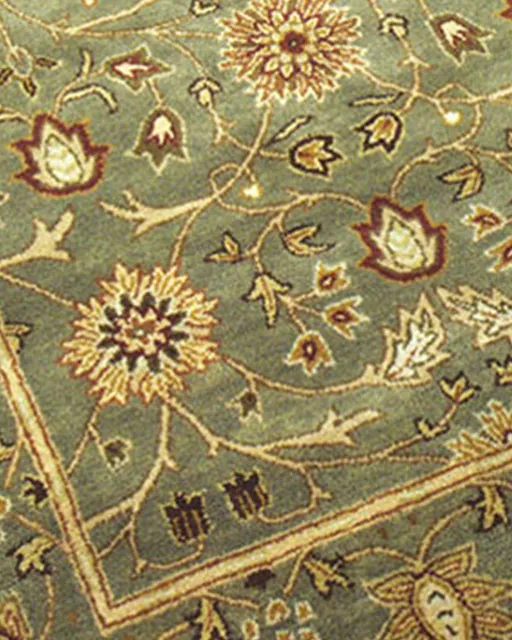 Green oriental rug with detailed floral border after cleaning