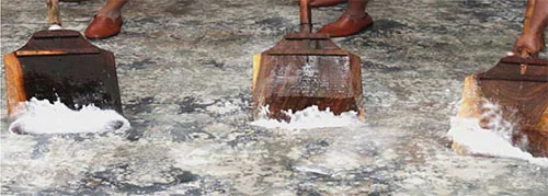 Oriental rug being washed by hand with traditional tools