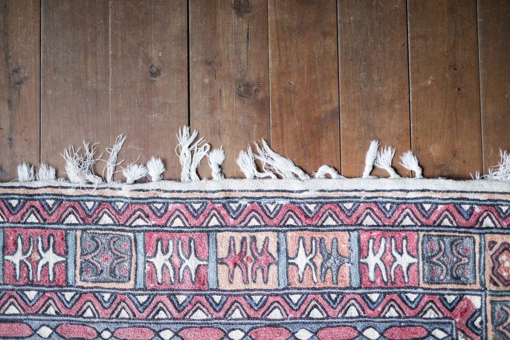 patterned oriental-style rug with its white fringe