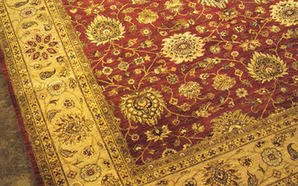 Red oriental rug with a gold border